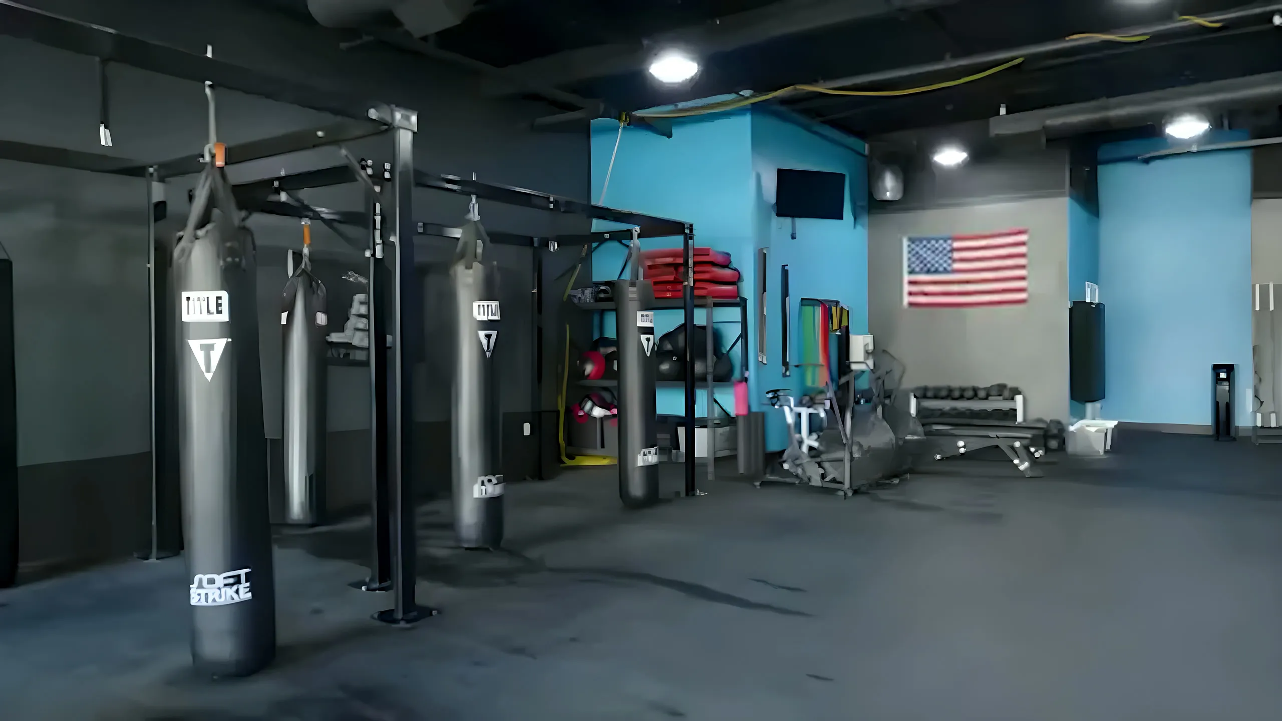 The kickboxing area at Title 29 Fitness — heavy bags and equipment wall